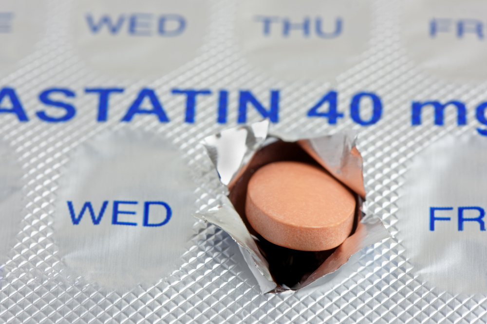 A statin tablet emerging from a marked weekly blister pack